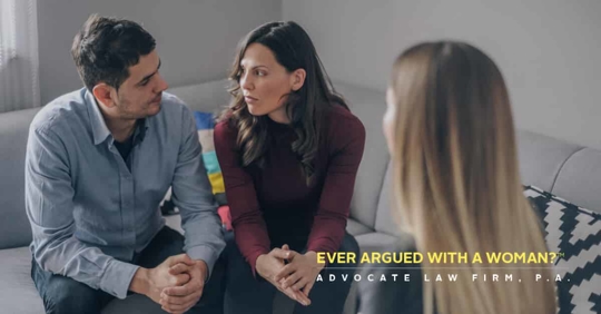 man and woman facing each other in front of other woman