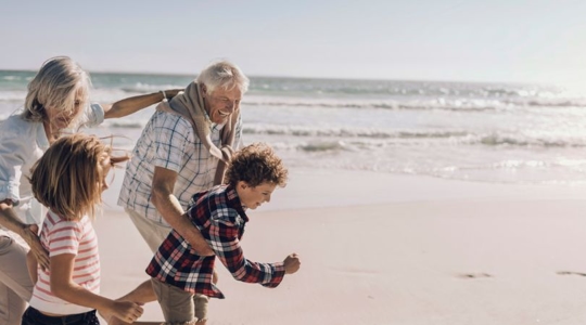 grandparents and children on beach