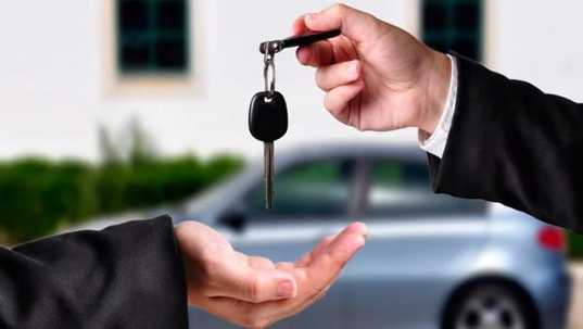 Person receiving their car keys from an insurance agent