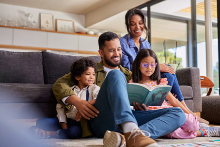 parents reading a book with their children