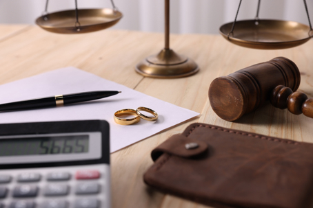 calculator, wedding rings, gavel, and a wallet