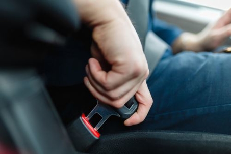 man putting on seatbelt