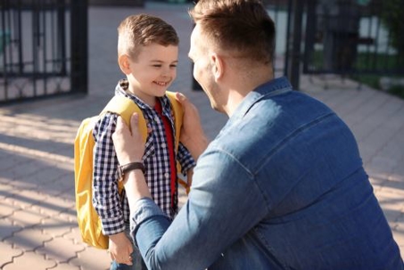 father with young son in a backpack